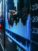 stock charts displayed on a city sidewalk through a glass window