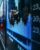 stock charts displayed on a city sidewalk through a glass window