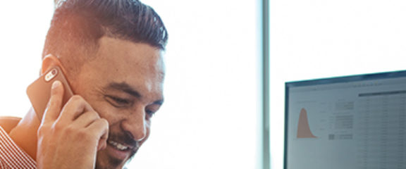 man on a phone in front of a desk